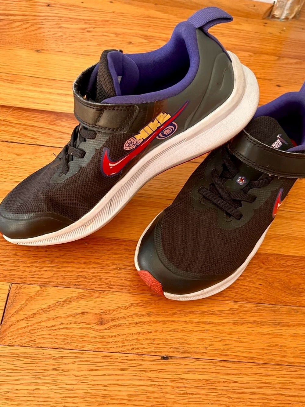 Nike Kids Black Sneakers with Red Swoosh and Purple Lining
